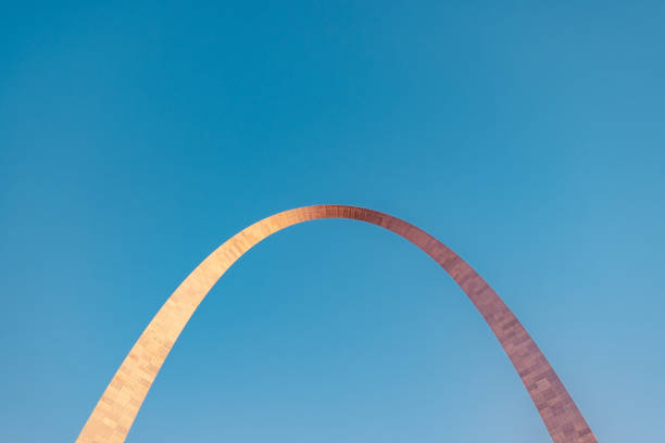 Sunset at the Gateway Arch At 630-foot (192 m), the stainless steel Gateway Arch in St. Louis is the world's tallest arch and the tallest man-made monument in the Western Hemisphere.  The arch was built as a monument to the westward expansion of the United States. jefferson national expansion memorial park stock pictures, royalty-free photos & images