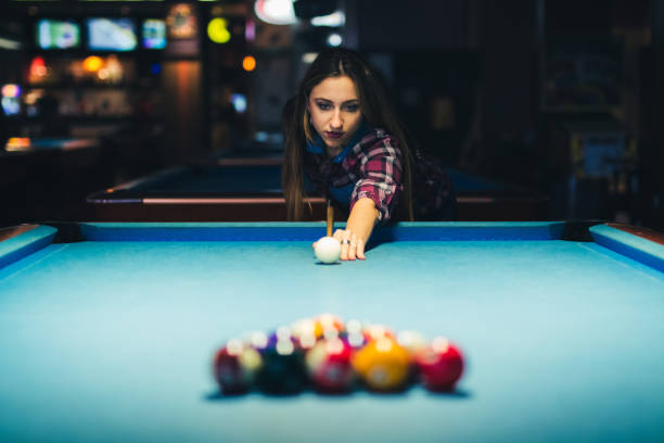 istock Young woman playing pool 1134535988