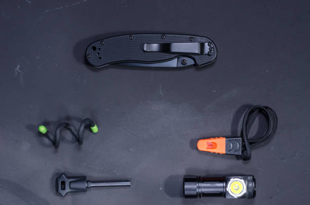istock Black items on a black background. Black knife with a clip. 1134537464