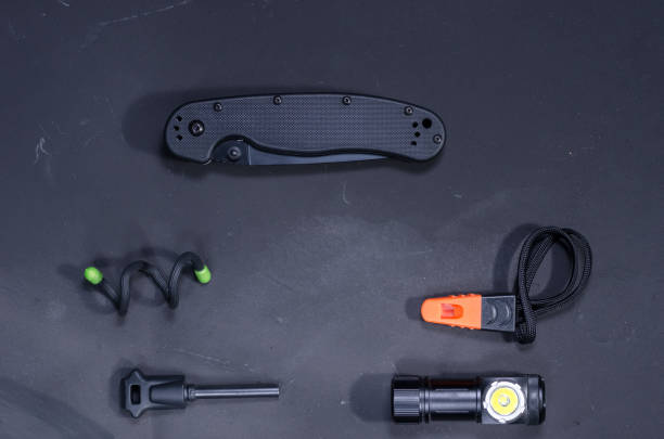 istock Black folded military knife. Black objects for survival. 1134537483