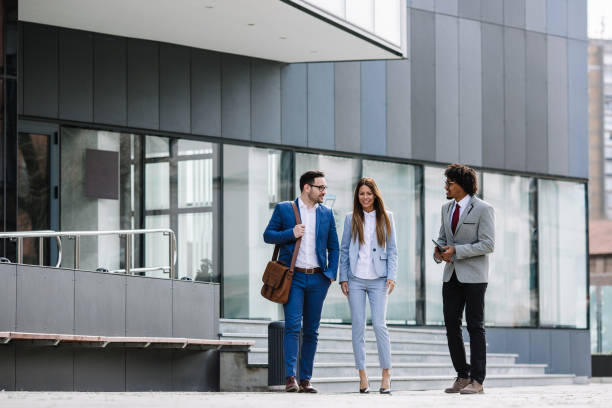 istock Smiling business colleagues walking outdoors and discussing. 1134537608