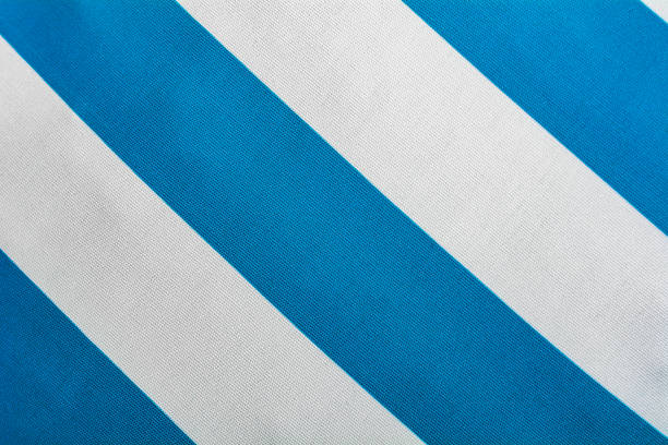 istock Blue and white background diagonal stripes pattern top view - Bicolor point of view on textile backdrop pattern - Wide line stripes of clothes 1134551837