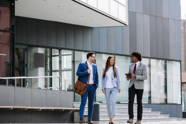 istock Smiling business colleagues walking outdoors and discussing. 1134558365