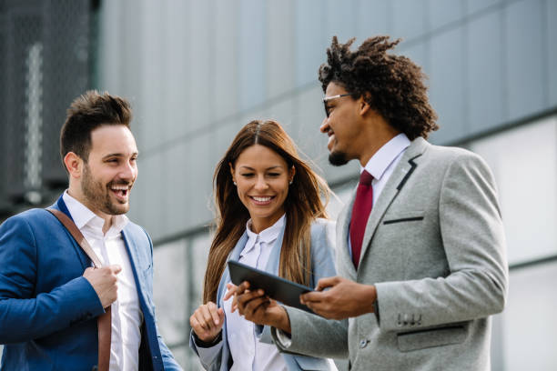 istock Happy business people walking outdoors and communicating. 1134559277