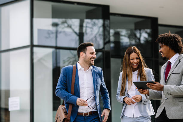 istock Smiling business colleagues walking outdoors and discussing. 1134559278