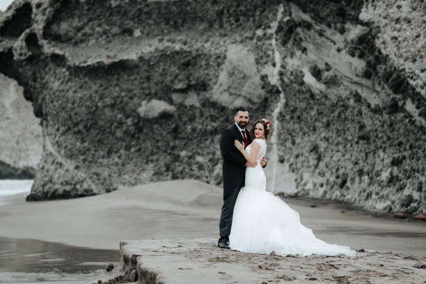 istock The bride and groom are walking along the beach. Panoramic view. 1134561119