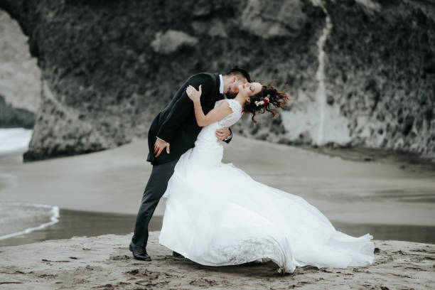 istock The bride and groom are walking along the beach. Panoramic view. 1134561120
