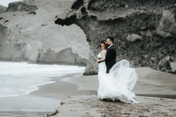 istock The bride and groom are walking along the beach. Panoramic view. 1134561123