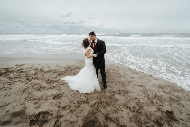 istock The bride and groom are walking along the beach. Panoramic view. 1134561128