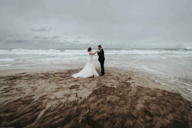 istock The bride and groom are walking along the beach. Panoramic view. 1134561132