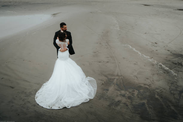 istock The bride and groom are walking along the beach. Panoramic view. 1134561170
