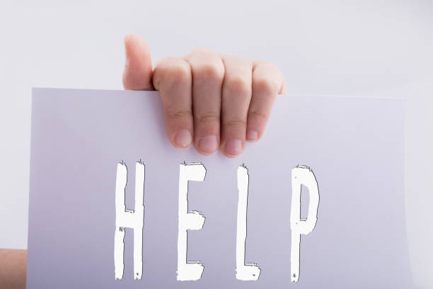 istock Help wording on paper in hand 1134564246