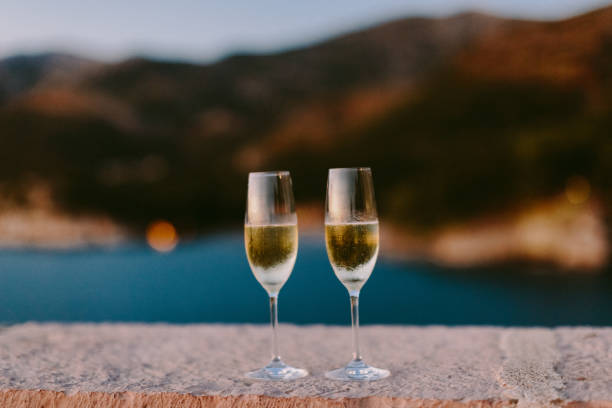 istock champagne glass at sunset on beach 1134565038