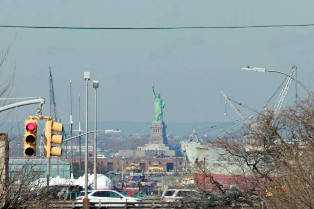 Statue of Liberty from Industrial Brooklyn Brooklyn, New York USA view down industrial street with Statue of Liberty in the Bay BQE stock pictures, royalty-free photos & images