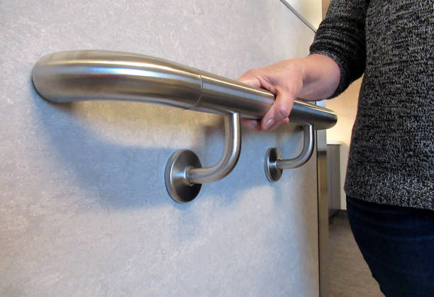 Lifestyle, " A Wall Mounted Hand Rail Support " Lifestyle...This low angle close up shot, shows a person holding onto a wall mounted hand rail for support, while walking. gripping stock pictures, royalty-free photos & images