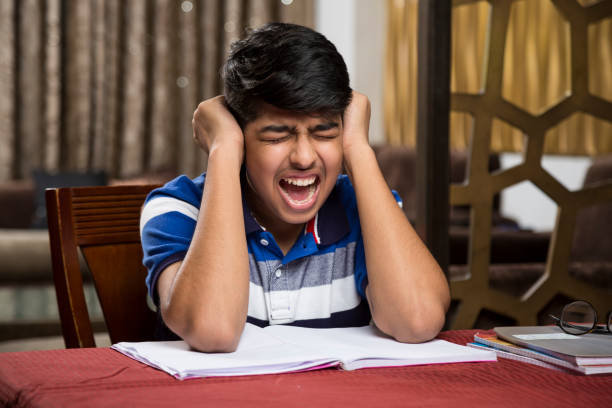 teeanger boy-stock images - reading and writing exam preparation education stock-fotos und bilder