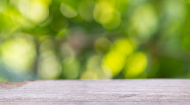 istock Old Table Top On Blur Bokeh Abstract Green From Garden Background. 1134579274