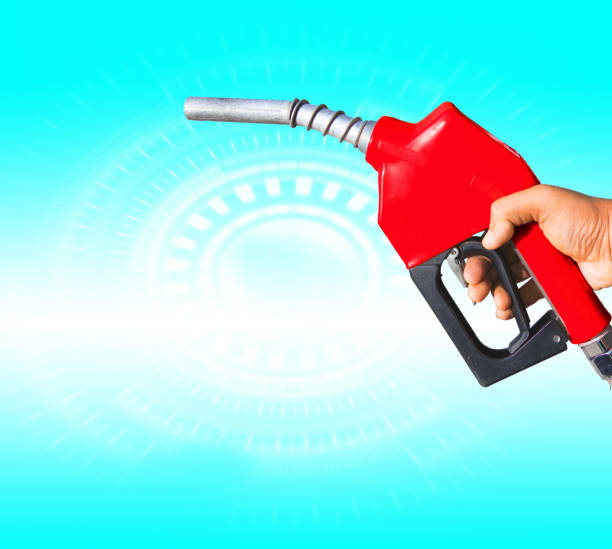 istock Fuel nozzle Hand holding red and white scenes that are separated from the ground. 1134582011