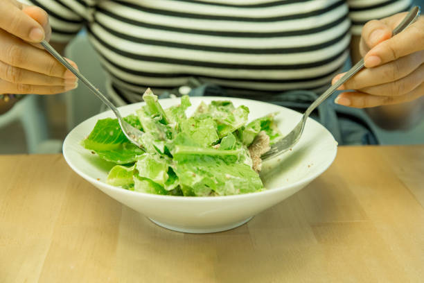 istock Women having Breakfast as salad with fork and spoon, focus selective 1134582772