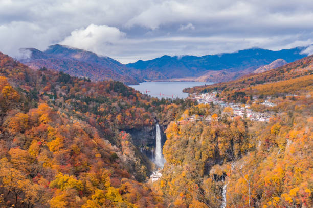 istock Beautiful waterfall in autumn forest from top view 1134582965