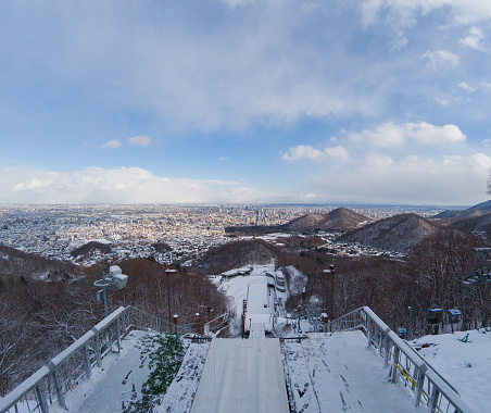 Ski jump stadium are covered with snow from top view in winter.