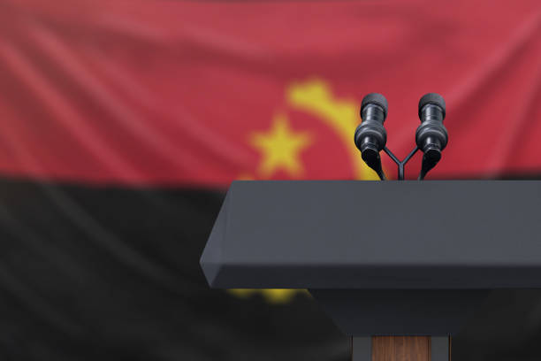 istock Angola Flag with podium and microphones 1134585145