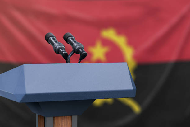 istock Angola Flag with podium and microphones 1134585151