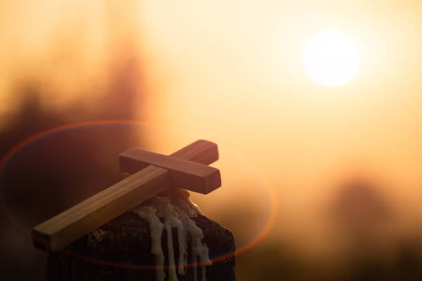 Christian wooden cross on a background with dramatic lighting,  Jesus Christ cross, Easter, resurrection concept. Christianity, Religion copyspace background.