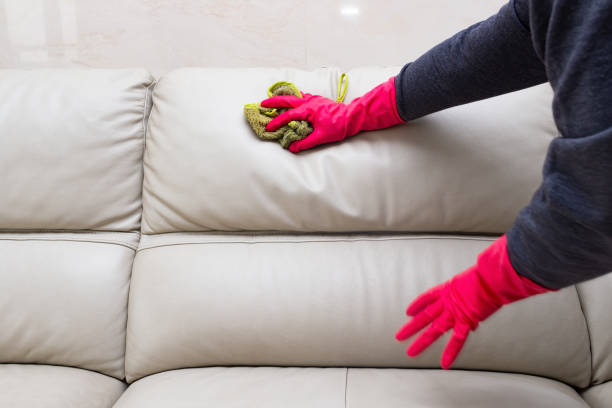 istock man cleaning leather sofa at home with wet towel 1134587911