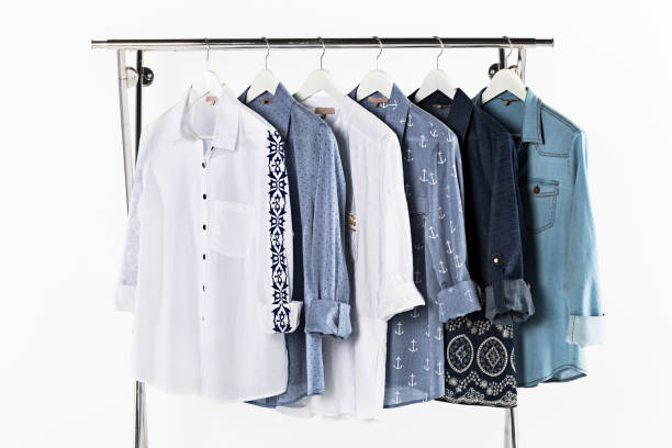camisas de mujer en colgadores de abrigo aislados sobre fondo blanco - barra para colgar la ropa fotografías e imágenes de stock