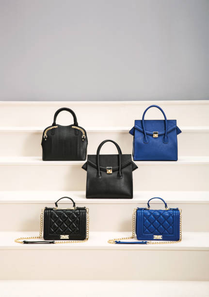 Fashionable handbags in a raw on showroom (with clipping path) Fashionable handbags in a raw on showroom (with clipping path) shoulder bag stock pictures, royalty-free photos & images