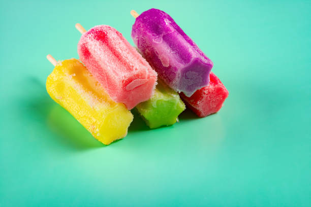 istock multi-color popsicles line up on green background with copy space 1134593007