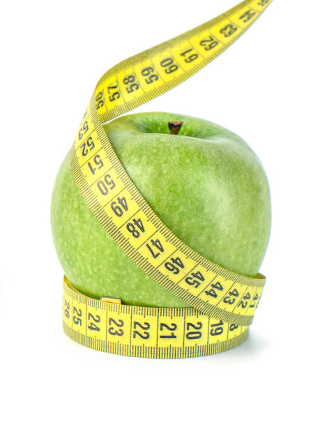 istock green apple with Measuring tape on white background 1134593598