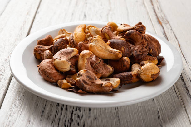 istock side view cashew nuts on a dish on white wood background 1134593767