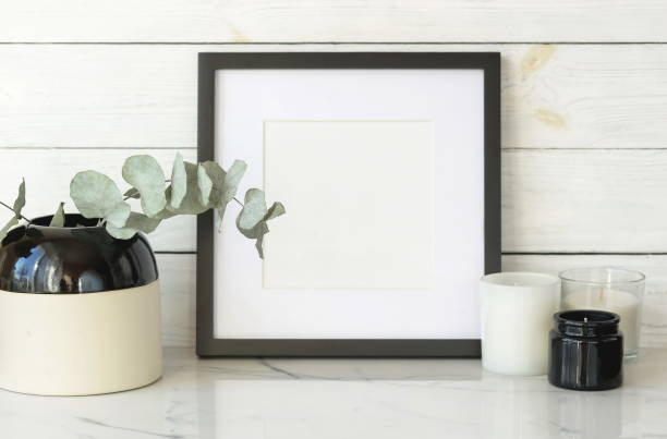 istock Interious background. frame mock up and dry eucalyptus twigs in vase on desk. 1134593814