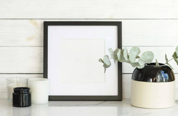 istock Interious background. frame mock up and dry eucalyptus twigs in vase on desk. 1134593873