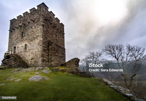 Magnificent Moody Sunset View Of The Tower Of The Crumbling Ruins Of Dolwyddelan In Snowdonia National Park Stock Photo - Download Image Now