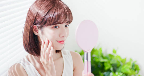 istock Young asian woman look mirror 1134594779