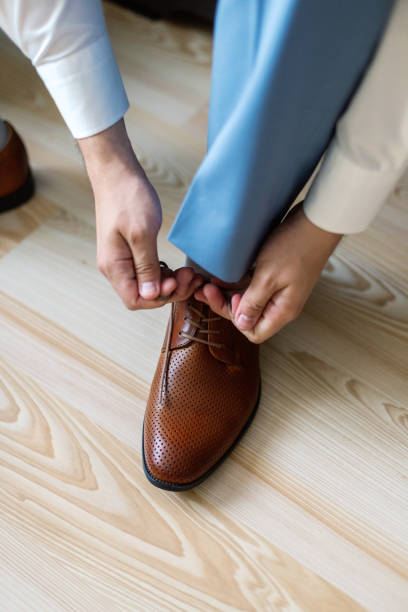 Business man dressing up with classic, elegant shoes. Groom wearing on wedding day, tying the laces and preparing Business man dressing up with classic, elegant shoes. Groom wearing on wedding day, tying the laces and preparing. lace fastener photos stock pictures, royalty-free photos & images