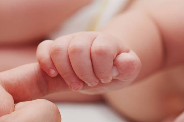 istock Small baby hand hold father finger 1134599413