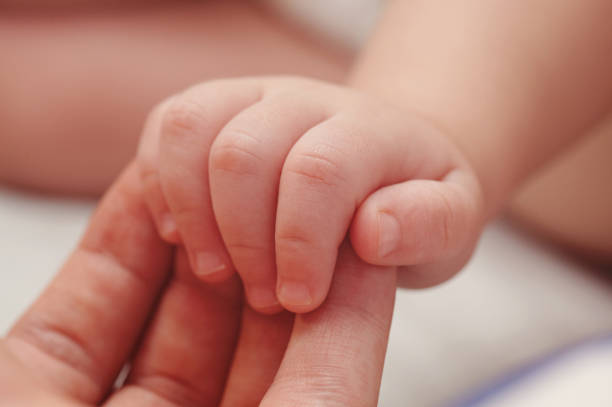 istock Baby hand on parent palm 1134599421