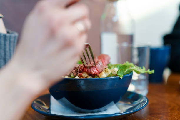 istock Eating fresh salad with meat and vegetables 1134602589