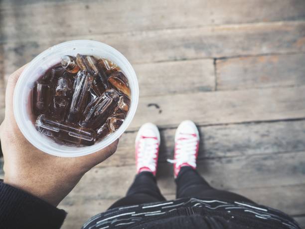 istock Selfie of cola drink with ice cubes on hand 1134605093