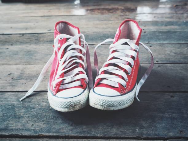 istock Red sneakers on wood background 1134605166