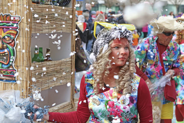 Confetti Flying Breitenbach, Switzerland - March 2, 2019: Floats carry costumed participants during the Fasnacht parade taking place in this village; Fasnacht is celebrated throughout Switzerland in order to 'chase winter' away and typically features parades, costumes, marching bands and good fun by the citizens of each town in the country over several days. fastnacht stock pictures, royalty-free photos & images