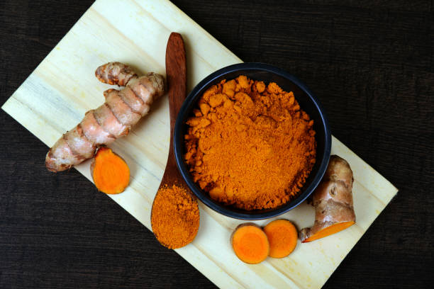 istock Organic Turmeric root and turmeric powder in a bowl 1134605612