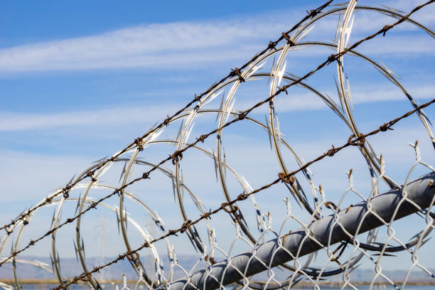 istock Razor barbed wire security fence, California 1134607285