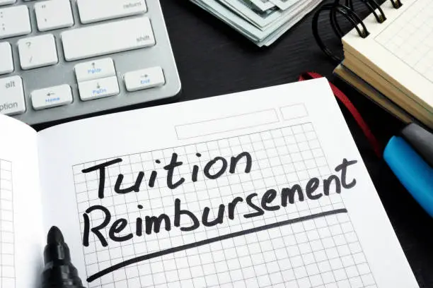 Photo of Tuition reimbursement written on a page of notepad.