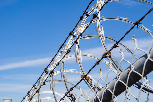 istock Razor barbed wire security fence, California 1134611677