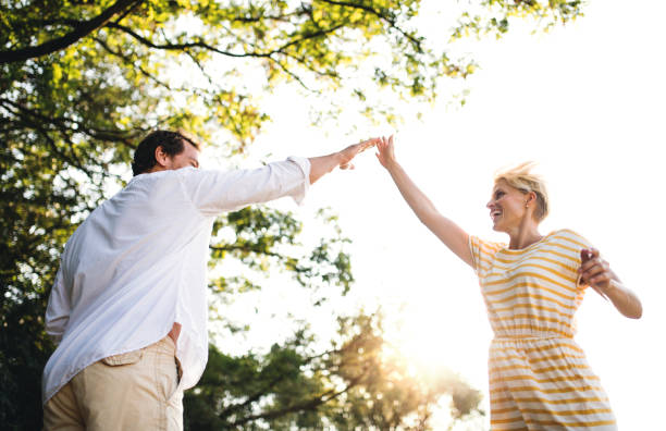 istock A young couple spending time together in nature in summer, making high five. 1134614405